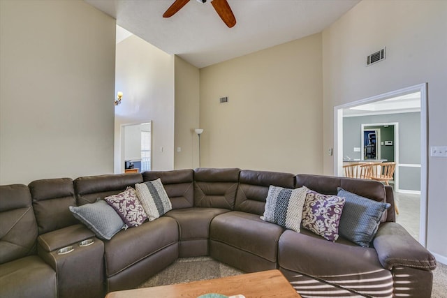 living room with carpet floors, high vaulted ceiling, and ceiling fan