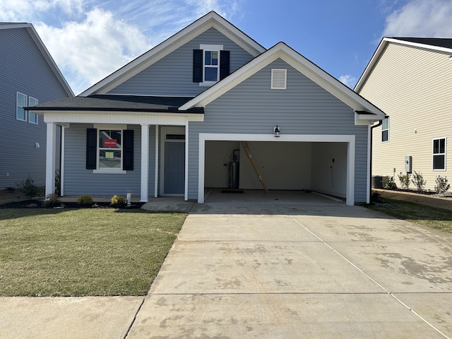 view of front of house featuring a garage, a front yard, and covered porch