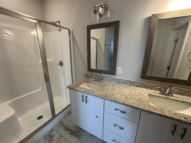 bathroom featuring vanity and a shower with door