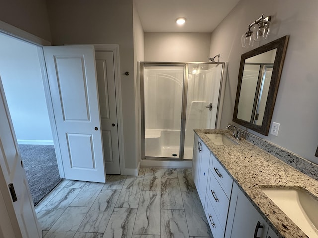 bathroom with vanity and a shower with shower door