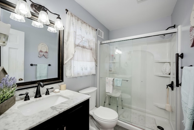 bathroom with vanity, toilet, and walk in shower