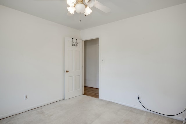 carpeted empty room with ceiling fan