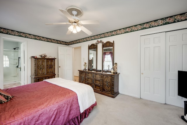 carpeted bedroom with ceiling fan, ensuite bath, and a closet