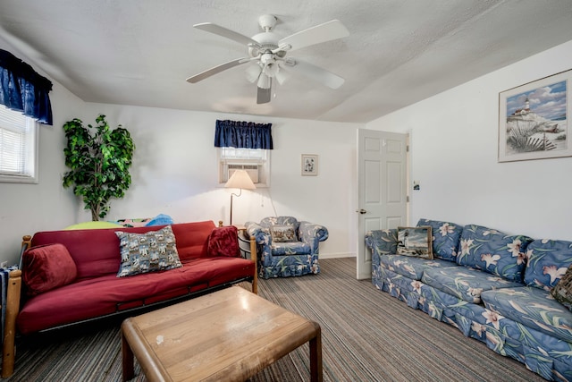 carpeted living room with a textured ceiling and ceiling fan