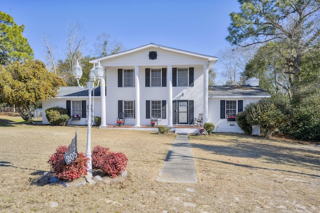 greek revival house with a front lawn