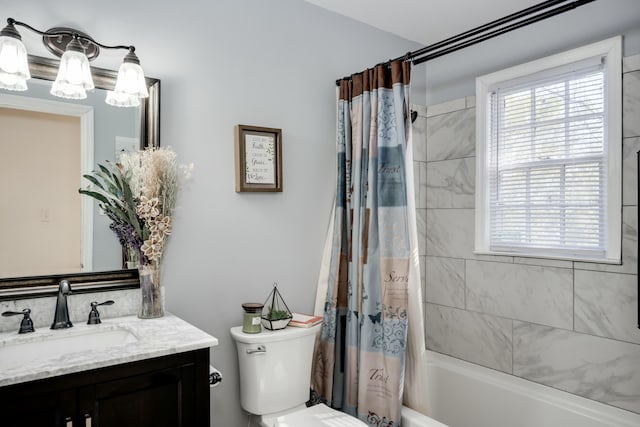 full bathroom with vanity, shower / tub combo, and toilet