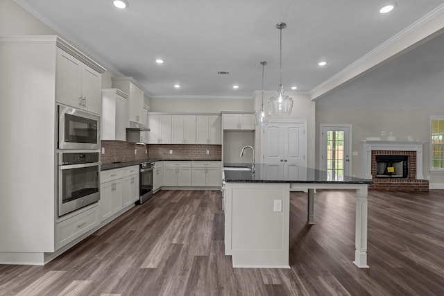 1216 Elbron Dr, Augusta, GA 30909 - kitchen with stainless steel oven, a sink, built in microwave, dark wood-style flooring, and crown molding