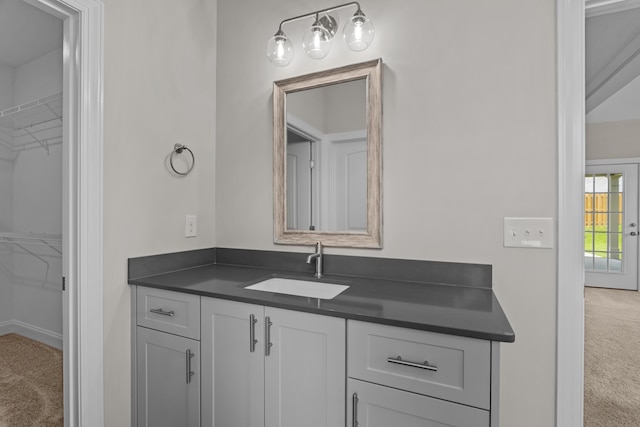 1216 Elbron Dr, Augusta, GA 30909 - bathroom with vanity, a walk in closet, and baseboards