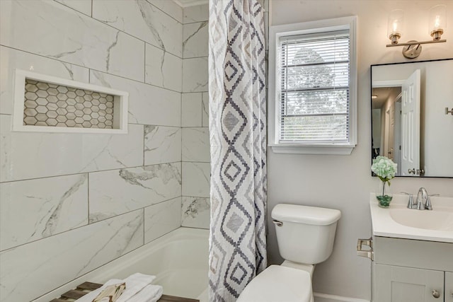 bathroom with toilet, vanity, and shower / tub combo