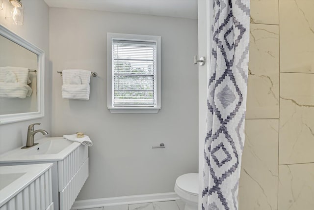 full bath featuring toilet, marble finish floor, a shower with shower curtain, baseboards, and vanity