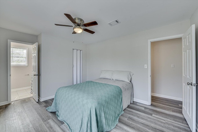 bedroom with visible vents, ceiling fan, baseboards, and wood finished floors