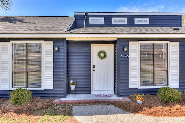 property entrance with roof with shingles