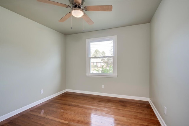 empty room with ceiling fan and wood-type flooring