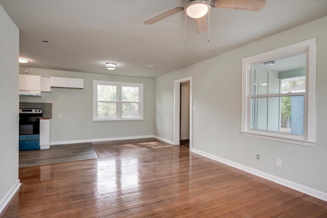 unfurnished living room with hardwood / wood-style floors and ceiling fan