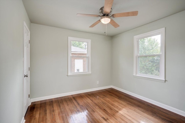 unfurnished room with hardwood / wood-style flooring and ceiling fan