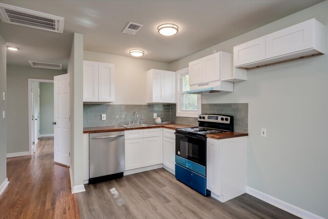 kitchen with dishwasher, white cabinetry, wood counters, and black range with electric stovetop