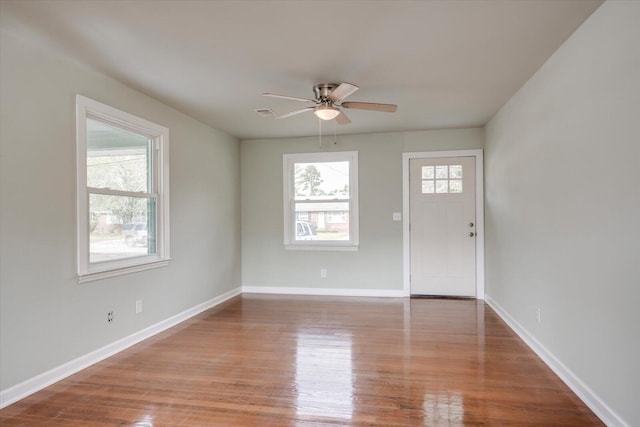 foyer entrance featuring wood-type flooring, ceiling fan, and a healthy amount of sunlight