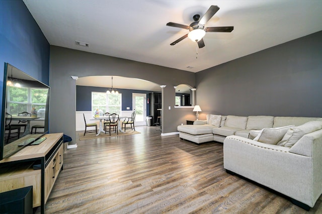 living room featuring hardwood / wood-style floors and ceiling fan with notable chandelier