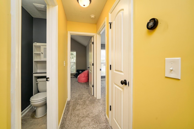 hallway with light colored carpet