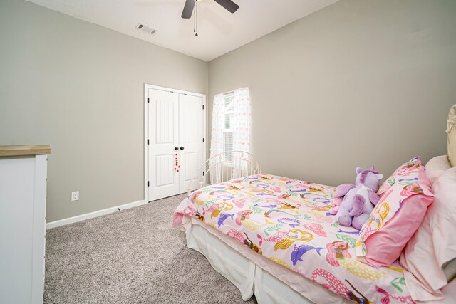 carpeted bedroom featuring ceiling fan and a closet