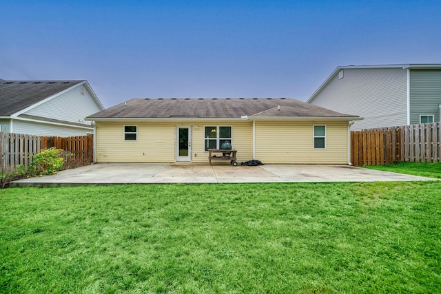 back of house with a patio area and a yard