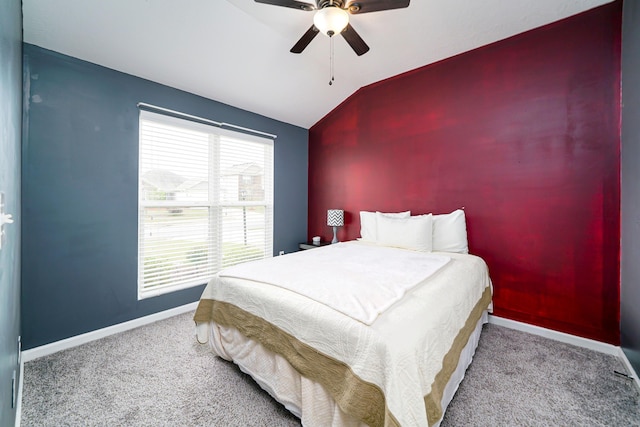 bedroom with ceiling fan, lofted ceiling, and light carpet