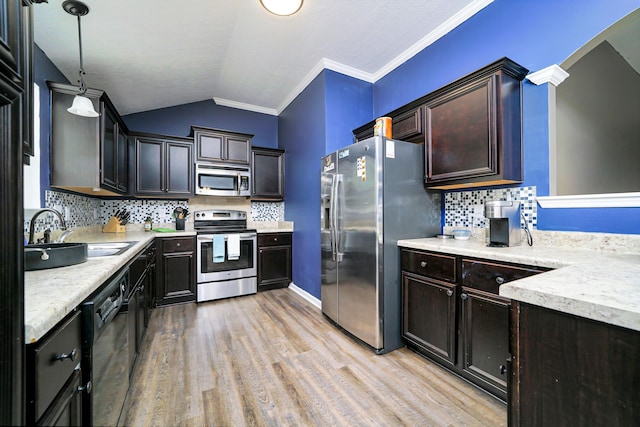 kitchen featuring lofted ceiling, sink, decorative backsplash, decorative light fixtures, and stainless steel appliances