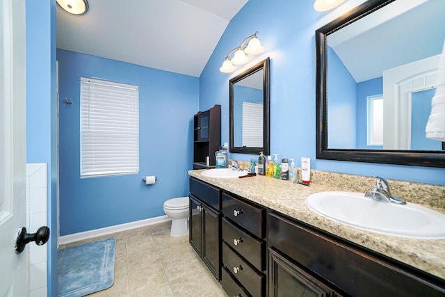 bathroom with tile patterned floors, vanity, toilet, and lofted ceiling