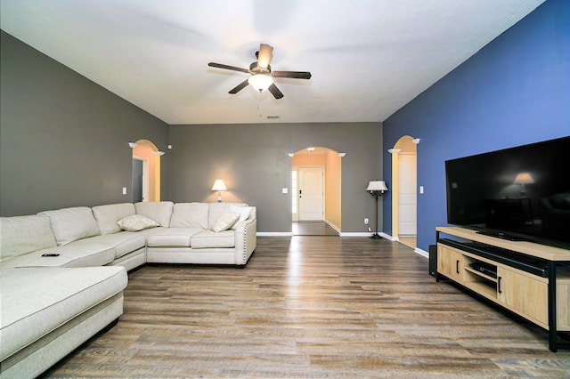 living room with wood-type flooring and ceiling fan