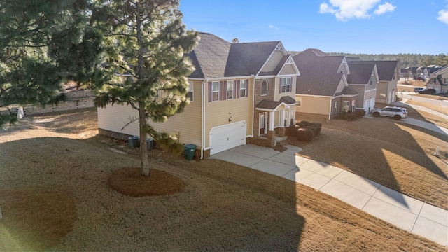 view of front of house featuring a garage and a front lawn