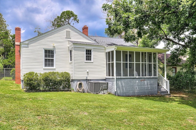 538 Hickman Rd, Augusta, GA 30904 - rear view of house with a sunroom, roof with shingles, and a chimney