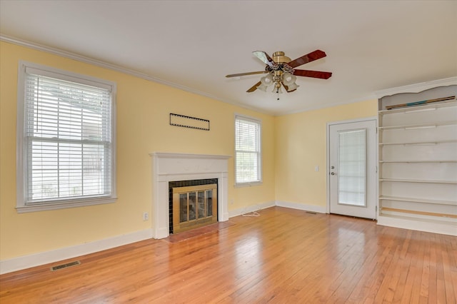 538 Hickman Rd, Augusta, GA 30904 - unfurnished living room with light wood-style floors, ceiling fan, a fireplace with flush hearth, and crown molding