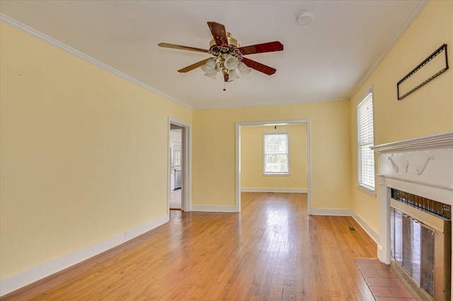 538 Hickman Rd, Augusta, GA 30904 - unfurnished living room featuring light wood-type flooring, ceiling fan, ornamental molding, and a fireplace