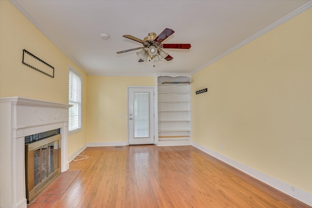 538 Hickman Rd, Augusta, GA 30904 - unfurnished living room with a tiled fireplace, light wood-style flooring, ceiling fan, and ornamental molding