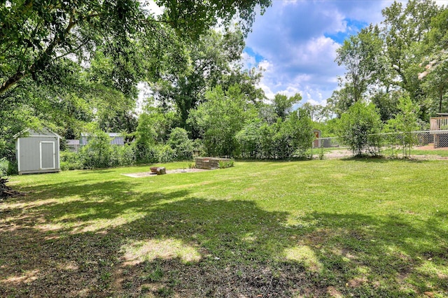 538 Hickman Rd, Augusta, GA 30904 - view of yard featuring a storage unit, a fire pit, and view of scattered trees