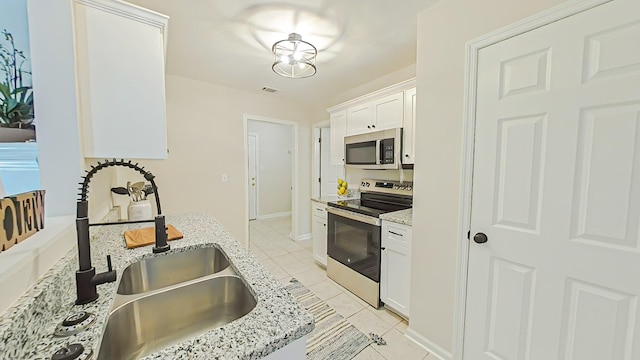 199 Crail Dr, Augusta, GA 30907 - kitchen with appliances with stainless steel finishes, a sink, white cabinetry, light tile patterned floors, and light stone countertops