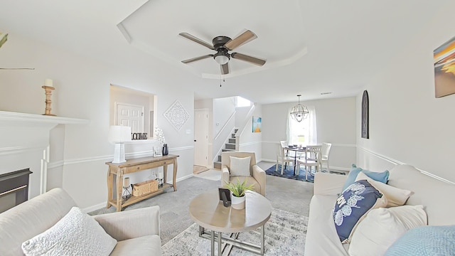 199 Crail Dr, Augusta, GA 30907 - living area featuring carpet, a ceiling fan, stairs, a tray ceiling, and a glass covered fireplace