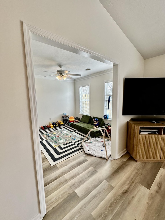 living room featuring ceiling fan and light wood-type flooring