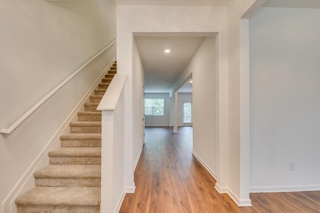 stairs with hardwood / wood-style floors