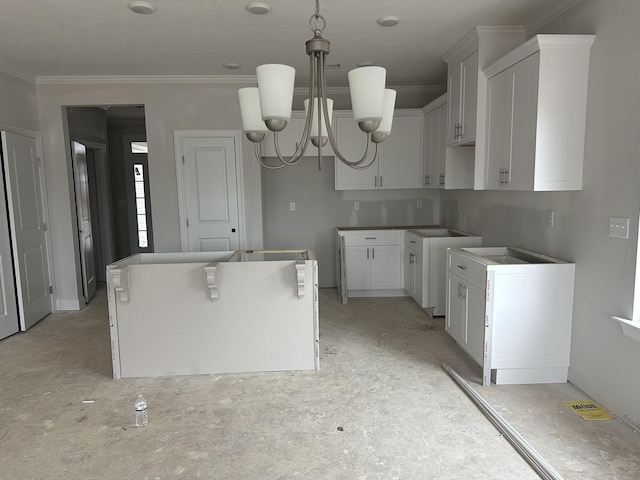 kitchen featuring ornamental molding, a center island, white cabinetry, a chandelier, and hanging light fixtures