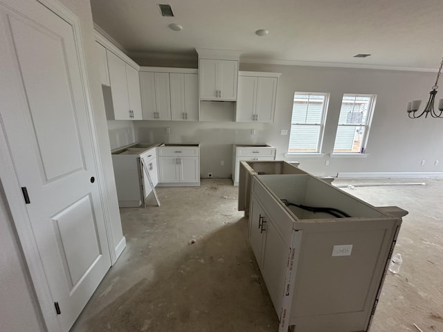 kitchen featuring visible vents, white cabinets, a kitchen island, and crown molding