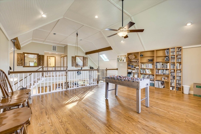 recreation room with visible vents, wood finished floors, lofted ceiling, and ceiling fan
