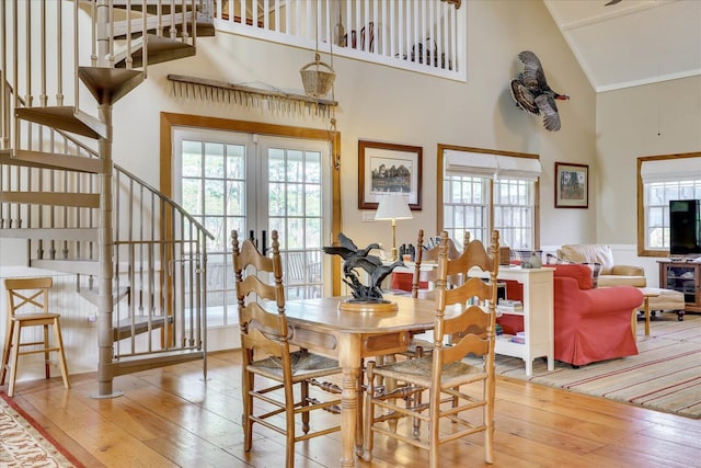 dining area featuring a wealth of natural light, stairs, and hardwood / wood-style flooring