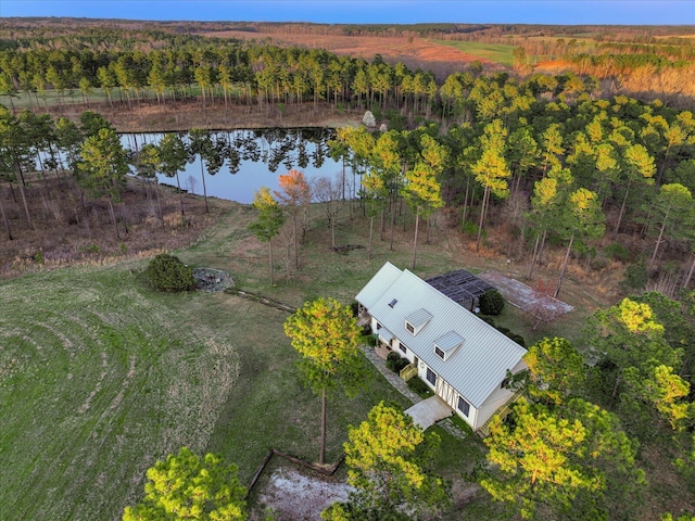 birds eye view of property featuring a view of trees and a water view