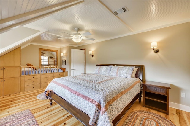 bedroom with a ceiling fan, visible vents, baseboards, lofted ceiling, and light wood-style flooring