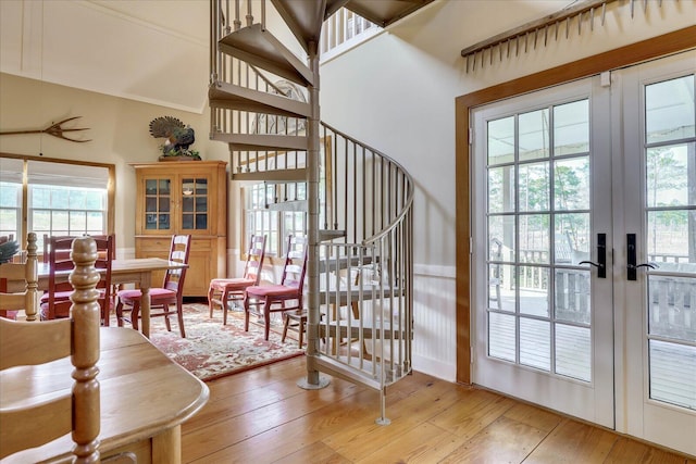 staircase featuring hardwood / wood-style flooring and french doors