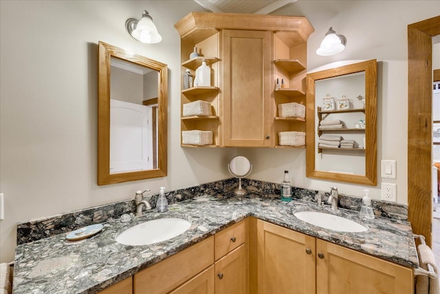 full bathroom featuring a sink and double vanity