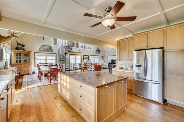 kitchen featuring light wood finished floors, light brown cabinetry, and stainless steel fridge with ice dispenser