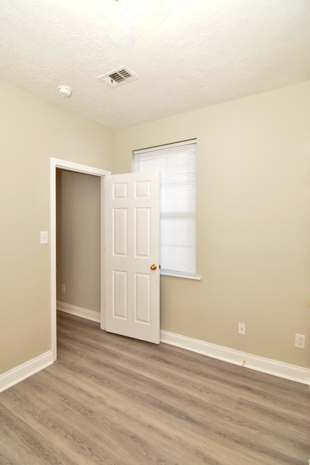 spare room featuring hardwood / wood-style flooring