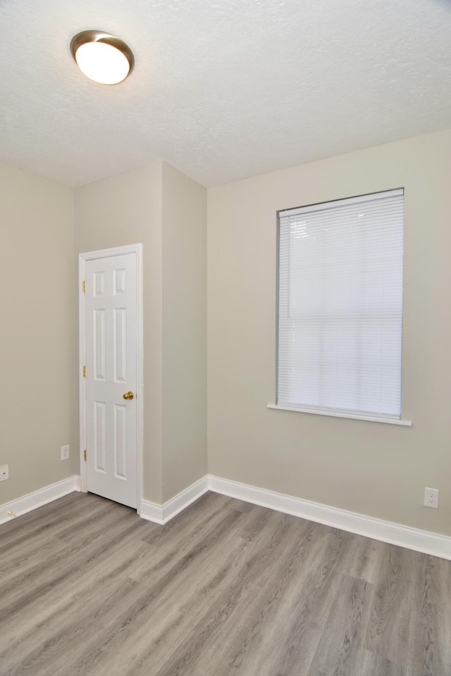 unfurnished room featuring hardwood / wood-style floors